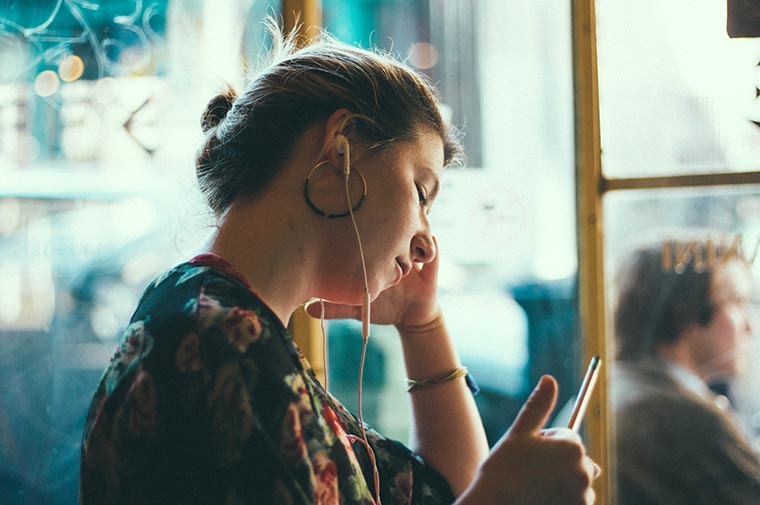 young woman with earbuds in 
