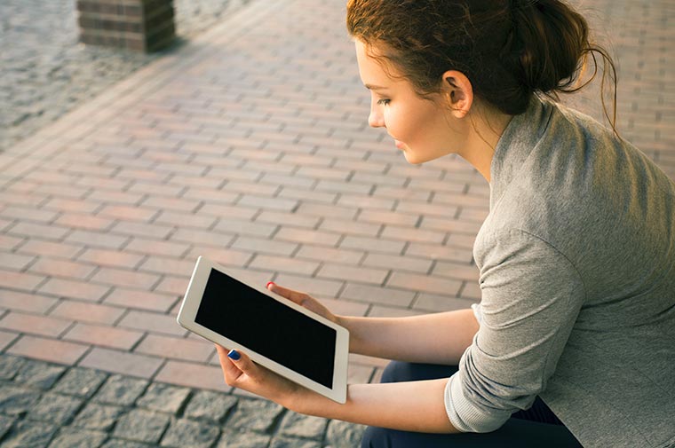 young woman looking at tablet
